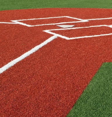 picture of a home plate in red artificial grass on a newly installed baseball field by Coyote Sports Turf