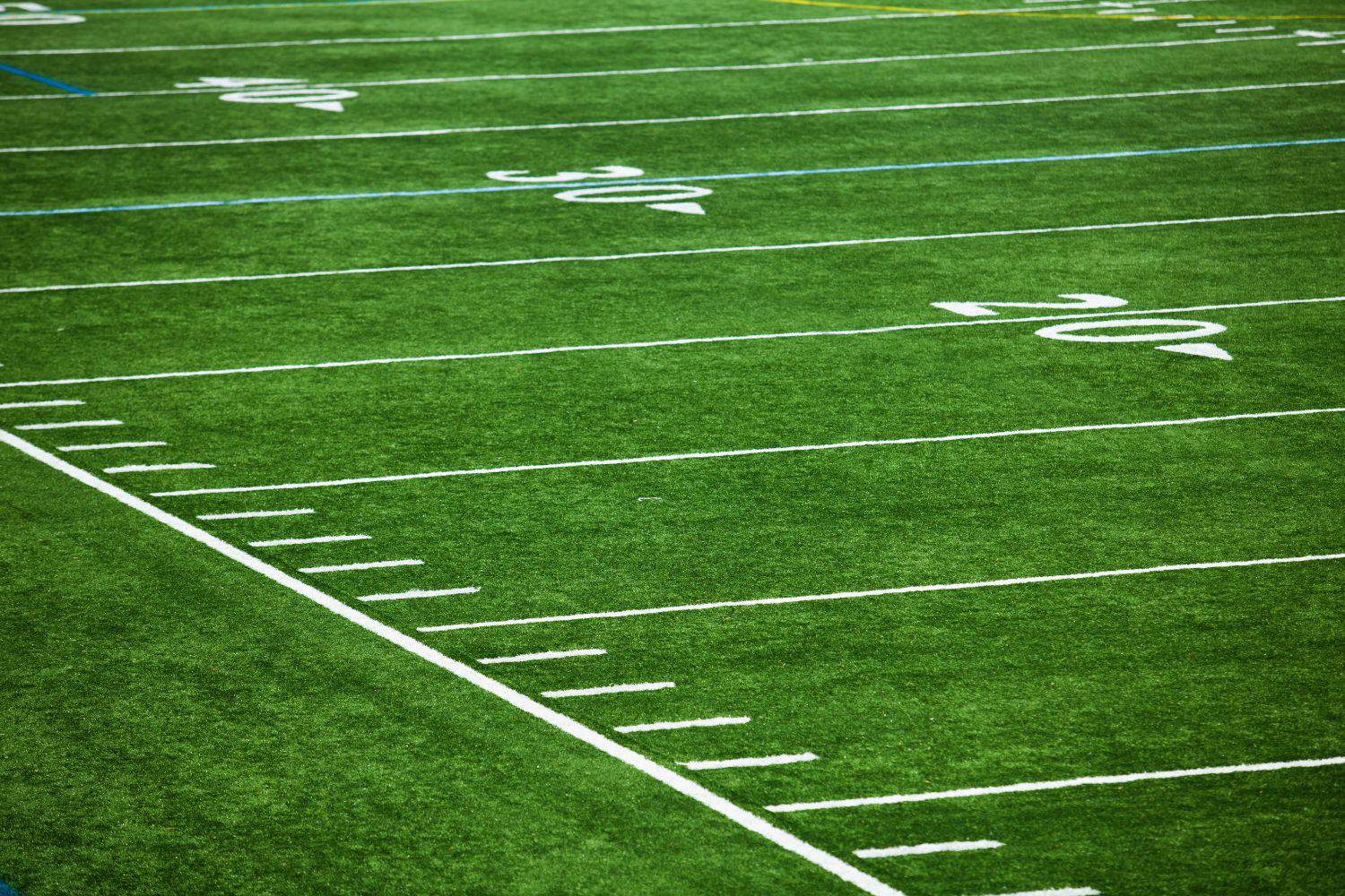 picture of a bright green artificial grass football field that was installed at a college in Arizona by Coyote Sports Turf